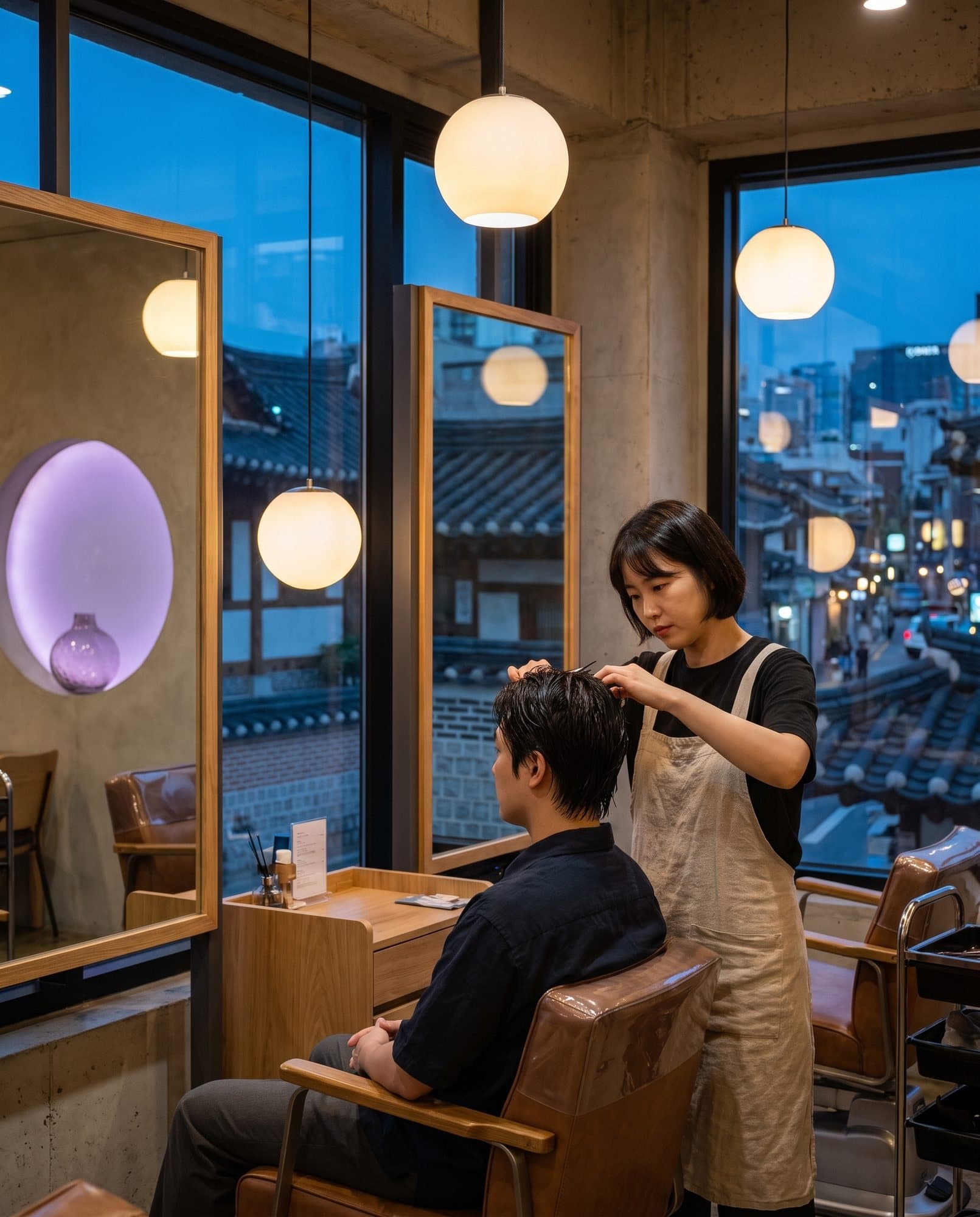 Hairdresser at work in a salon at blue hour